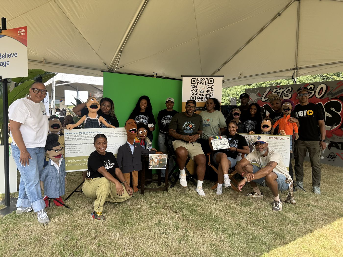 The Make Believe Village crew and puppets under the tent at Russell Rocks the Block