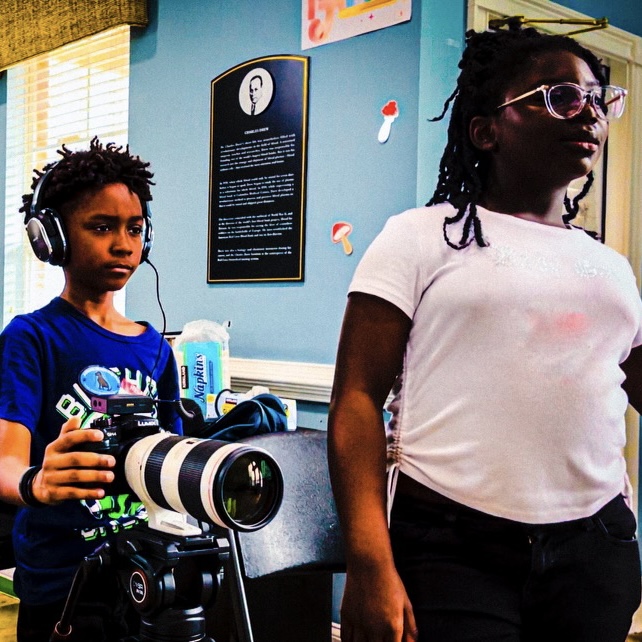 students directing a film and using the camera